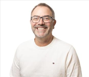 A SERVPRO® employee in front of a white background