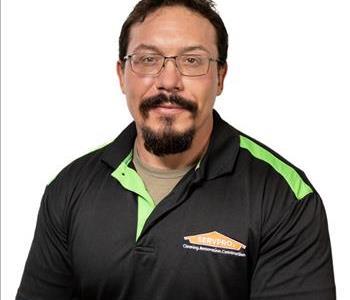 SERVPRO® employee in front of grey background