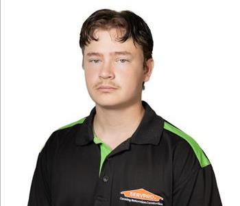 A SERVPRO® employee in front of a white background