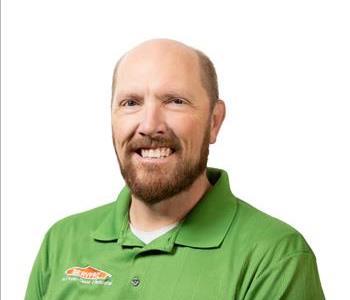 A SERVPRO® employee in front of a white background